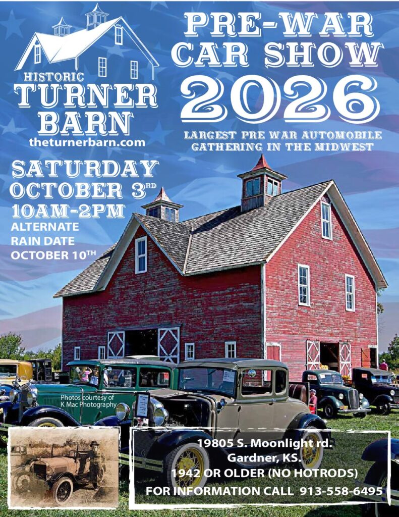 Red barn with vintage tractors at a farm event in October 2026.